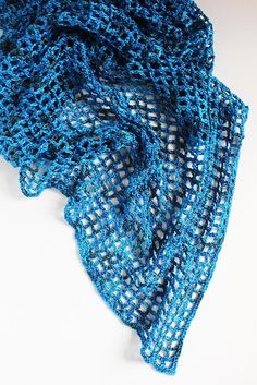 a close up of a blue scarf on a white surface