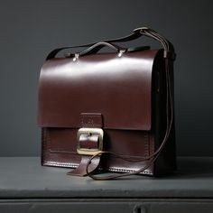 Fantastic leather satchel for formal wear, take it into the office or into those meetings where you might need anything or everything. Big enough for documents, diaries and your laptop, with the choice of shoulder strap and handle. Using the finest British Saddlery Leather, Axel Jule is handmade in our workshop to order, meaning that each piece is unique to you and can be personalised further with your initials. - strap Length 130cm approx (51") - 31cm(h) x 38cm(l) x 9cm(d) approx (12" x 15" x 3 Professional Leather Satchel For Work, School Satchel Briefcase With Laptop Sleeve, Office Satchel Saddle Bag, School Briefcase With Laptop Sleeve And Satchel Shape, Professional Leather Office Satchel, Professional Leather Satchel For Office, Leather Satchel For Work, Professional Satchel Shoulder Bag For Office, Leather Shoulder Briefcase For Work