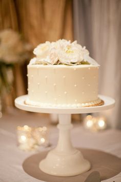 a wedding cake with white flowers on top