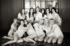 a group of women in white robes posing for a photo