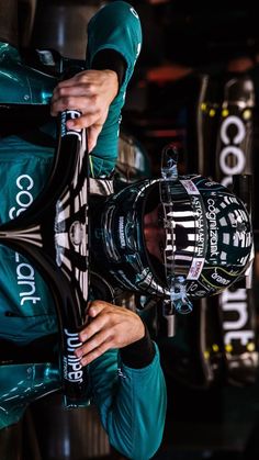 a man holding onto the back of a racing car