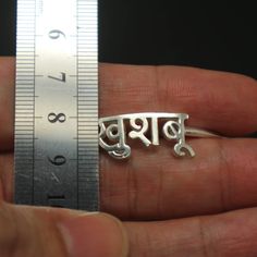 "Personalized Hindu Name Bracelet is handmade with its own uniqueness. It can be bought as a gift for any occasion like birthday gift, wedding gift, travel gift, souvenir and etc. If you need rose gold plating or yellow gold plating, please contact us, we will advice you on the additional fees applicable. Base Material: Sterling Silver Size: 11mm (Approximately) Bangle wrist size: 7'' - 8'' Inches. Adjustable / Please give us your wrist circumference. Stone: Red CZ setting (Default) Or check wit Spiritual Silver Jewelry With Custom Name, Symbolic Adjustable Jewelry For Birthday, Adjustable Symbolic Jewelry For Birthday, Spiritual Jewelry With Custom Name For Gift, Custom Name Spiritual Silver Jewelry, Handmade Silver Bracelet For Birthday, Symbolic Personalized Bracelets As Gifts, Handmade Round Name Bracelet For Birthday, Spiritual Name Jewelry For Weddings