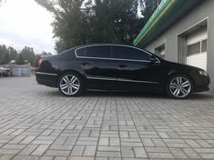 a black car parked in front of a garage