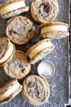 chocolate chip cookies and cream cheesecakes on a baking sheet with a cup of coffee