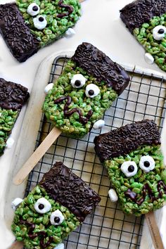 green monster rice krispy treats with eyes and googly eyes on them, sitting on a cooling rack