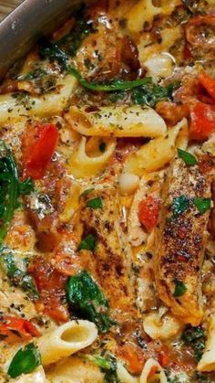 a pan filled with pasta and vegetables on top of a wooden table