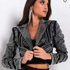 A Gorgeous Beautiful Rhinestone Crop Style Jacket Embellishments Cover The Entire Jacket Make It A Statement All By Itself It Has One Button For Closure Which Looks So Good Open Instead It Could Be Formal Wear Or Casual Wear With Jeans Or In Between A Unique Piece Definitely. Glamorous Fitted Blazer With Rhinestones, Elegant Black Blazer With Rhinestones, Elegant Fitted Blazer With Rhinestones, Luxury Rhinestone Blazer For Parties, Luxury Party Blazer With Rhinestones, Luxury Rhinestone Party Blazer, Fitted Rhinestone Blazer For Party, Fitted Party Blazer With Rhinestones, Glamorous Party Blazer With Rhinestones