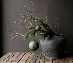 a potted plant sitting on top of a wooden table next to an ornament