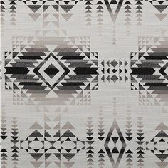 an area rug with black and white designs on the front, grey back and beige sides