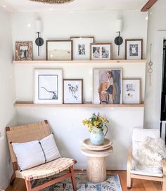 a living room filled with lots of furniture and pictures on the wall above it's shelves