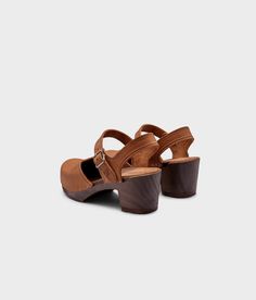 Step up your style game with Victoria, the classic clog sandal that's a bestseller for a reason. With its timeless design and unbeatable comfort, you'll strut confidently through any occasion in these high-heel stunners. Clog measurements:Heel height: 2 5/8” (6.5 cm)Toe height: 1 1/2” (3.8 cm)Fit:NarrowLeather:Nubuck leatherClogs consist of:Base: European Lime WoodSole: Rubber soleFastening: StaplesOther: Metallic buckle Classic Sandals With Heel Strap And Round Toe, Classic Clogs With Reinforced Heel, Classic Sandals With Wooden Heel For Summer, Classic Spring Clogs With Wooden Heel, Classic Sandals With Wooden Open Heel, Classic Sandals With Wooden Heel And Open Heel Design, Classic Open-heel Sandals With Wooden Heel, Brown Slingback Heels With Cushioned Footbed, Classic Slingback Sandals With Heel Loop