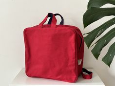 "Hot red square backpack made with paraffin waxed canvas (army duck). It's beautiful and sturdy! Waxed canvas is perfect for rainy days because it's water resistant material and stuff inside will be saved from getting wet! (The lining is made with nylon) There are back pockets that can keep your belongings safe and one big pocket inside! --size--  12\" x 12\"x 5\"  The short handles and adjustable straps can make you carry this bag differently!" Square Backpack, Big Pocket, Red Square, Paraffin Wax, Waxed Canvas, Backpack Purse, Rainy Days, Inside Pocket, Adjustable Straps