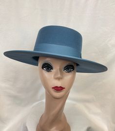 This dusty blue wool felt 3.5-inch brim gambler-style hat has a ribbon edge around the brim. This hat has a flat stiff brim. The hat is trimmed with a dusty blue 1 1/2 inch grosgrain ribbon band. The inside brim has a sizing band and will fit up to 22 7/8 inch head size. The inside is lined with satin ribbon. NOTE: Please check the head size before purchase, I am happy to answer any questions you may have. There will be a 20% restocking fee for all returned hats. Rigid Flat Brim Felt Hat For Country Events, Kentucky Derby Felt Hat With Flat Crown, Classic Blue Winter Hat, Solid Color Fur Felt Top Hat With Wide Brim, Solid Fur Felt Top Hat With Wide Brim, Western Solid Brimmed Boater Hat, Blue Western Hat For Kentucky Derby, Solid Wide Brim Top Hat In Fur Felt, Blue Wide Brim Hat For Rodeo