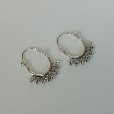 A PAIR of indian style sterling silver ear hoops. Size: 18 x 20 mm Price listed is for a pair of ear hoops. These earrings are made of 925 hypoallergenic sterling silver. All my pieces are sent in a gift box. I can include a personal message from you if needed. You are welcome to contact me at... bhavnakwintra1956@gmail.com More hoops: https://www.etsy.com/your/shops/TheSilverGame/tools/listings/section:26305414 More earrings: https://www.etsy.com/your/shops/TheSilverGame/tools/listings/section: Small Hoop Earrings For Festival, Bohemian Small Hoop Single Cartilage Earring, Dangle Hoop Earrings With Ear Wire For Festival, Small Hoop Single Earring For Festival, Dangle Hoop Earrings For Festival, Hoop Cartilage Earrings For Festivals, Single Dangle Hoop Earring For Festivals, Sterling Silver Dangle Hoop Earrings For Festivals, Festival Dangle Cartilage Earrings With Ear Wire