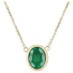 This stunning emerald necklace features a beautiful oval-cut emerald with a vivid medium green hue. The emerald is securely bezel set in a 14k gold solitaire pendant that measures 18 inches in length. The pendant is attached to a thin cable chain, ensuring that the pendant stays in place while wearing. The overall design is simple yet elegant, making it a versatile piece that can be worn on any occasion. Whether you're dressing up for a formal event or adding a touch of elegance to your everyday Zambian Emerald, Emerald Necklace, Solitaire Pendant, Semi Transparent, Bezel Setting, Cable Chain, Oval Cut, Chain Lengths, Formal Event