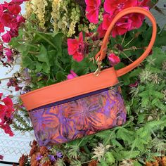 "Delicious Orange Leather combined with a hot,Orange Purple Batik..Those colors together end up looking a lot like Fall in the Finger Lakes! It's a minimalist Handbag,Wristlet, Clutch, Wallet ,or Phone Case. Top zip opens to roomy interior that will fit the largest Phone and a small pocket for your credit cards. AND there's a clip off key ring! Outside features one large zip pocket. 7.5\" wide 4.75\" deep 1.25 bottom" Orange Rectangular Coin Purse For Daily Use, Orange Pouch Clutch For Daily Use, Orange Bags With Removable Pouch For Gifts, Purple Rectangular Coin Purse For Everyday Use, Orange Pouch Wallet For Daily Use, Orange Pouch Clutch For Everyday Use, Orange Zipper Pouch Bag For Gift, Rectangular Purple Coin Purse For Everyday Use, Orange Pouch Bag For On-the-go