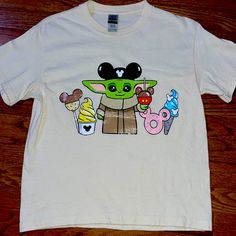 a t - shirt with an image of baby yoda and ice cream on it