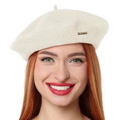 a woman with red hair wearing a white beret and smiling at the camera,