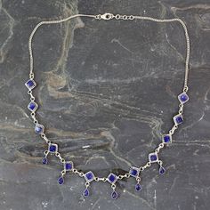 Lapis lazuli diamonds hold deep blue teardrops their gold-flecked charisma enhanced by silver settings. Suspended on a sterling chain the gems grace a regal waterfall necklace by Neeru Goel. .925 Sterling silver Queen Of Diamonds, Waterfall Necklace, Garnet Pendant, Sterling Silver Drop Earrings, Silver Jewelry Pendant, Birthday Wishlist, White Necklace, Silver Band Ring, Necklace Online