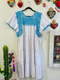 Our San Antonino dresses are unique, beautiful and perfect for any fiesta, a day at the beach or a formal event. You can easily dress it up or dress it down. Our dresses are completely hand embroidered by Artisans in Oaxaca, Mexico. It takes approximately 1 month to complete one dress.  Our San Antonino dresses are one of a kind. You will fall in love with every single detail. Each dress is hand embroidered on front chest area, sides and back with tiny floral designs inspired by the flowers in t Fiesta Dress, Mexican Embroidered Dress, Mexican Dresses, Beautiful Color Combinations, Embroidered Dress, Formal Event, Color Combinations, Dress Clothes For Women, Hand Embroidered