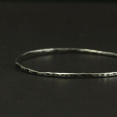 Add some rustic charm to your outfit or stack it with other bangles to add a little texture! This bangle is handmade just for you to the size of your choosing. It will be hand formed from 2mm diameter solid Sterling Silver round stock and hammered for a unique texture. Your bangle will then be oxidized and given a soft brushed finish to truly show off surface. This listing is for the Hammered Bangle ONLY. Please visit our shop for the bangles in the other photos. Blazer Arts is a family-owned an Minimalist Hammered Sterling Silver Bangle, Minimalist Hammered Sterling Silver Bangle Bracelet, Minimalist Hammered Silver Bangle, Minimalist Silver Hammered Bangle, Silver Hammered Round Bangle, Hammered Silver Round Bangle, Hammered Sterling Silver Round Bracelets, Hammered Sterling Silver Bangle Bracelet Gift, Hammered Sterling Silver Bracelets