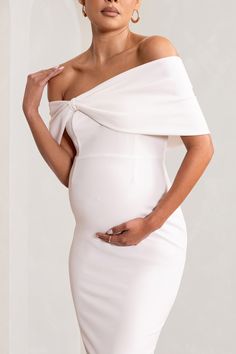 Meet Alyssa. our must-have midi dress made from a bright white jersey that's both supportive and sculpting. Sure to turn heads at any formal event from birthdays to baby showers. this white maternity dress features a Bardot neckline wrapped by a large bow and a split fitted skirt.Features- Premium stretch jersey- Bardot neckline- Large bow detail- Darted bodice- Bodycon fit- Invisible zip closure- Split hemline- Midi lengthSizing & FitModel is 5'8.5" and wears UK size 8 / US size 4Product Inform White Maternity Dress, White Maternity Dresses, Dress With Ruching, Bardot Neckline, Maternity Midi Dress, Black Dress Prom, Black Tie Gala, Party Dress Long Sleeve, Bridesmaid Outfit