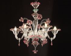 a fancy chandelier with pink flowers on it