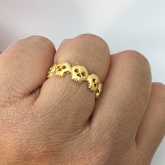 Handmade skull eternity ring made from sterling silver and plated in genuine yellow gold. Approximate dimensions Metal: high quality 925 sterling silver Plating: 24K yellow gold Skull width: 6mm Skull height: 6mm Thickness: 1.5mm Following sizes can ship within 1-2 business days. Size 5, 5.25, 5.5, 5.75, 6, 7, 7.25, 7.50, 7.75, 8, 8.25, 8.5, 8.75, 9 4-6 weeks production lead time for sizes that are not listed as in stock. We can make US ring size 4 to 14. Please contact us to start a cust... Gothic Gold Rings For Anniversary, Gold Gothic Jewelry For Anniversary, Gold Gothic Wedding Rings, Interesting Wedding Rings, Skull Wedding Ring, Gothic Engagement Ring, Skull Engagement Ring, Handmade Skulls, Skull Rings