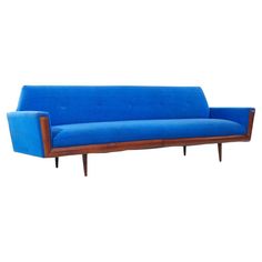 a blue couch sitting on top of a wooden frame