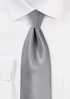 A Formal Silver Small Texture Necktie can be a great accessory to add a touch of elegance and sophistication to a variety of formal occasions, including shopping for suits, tuxedos, and men's suits for weddings. When shopping for suits, a silver small texture necktie can be paired with a variety of suit colors, such as black, navy blue, charcoal gray, or even light gray. It's a classic and timeless choice that can complement any outfit. When shopping for a tuxedo, a silver small texture necktie