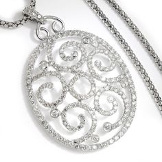 Description: A whirlpool of diamonds are beautifully showcased in this oval pendant. The pendant and necklace are made of solid 14kt white gold and feature 5.00 carats of natural round brilliant cut diamonds in both shared-prong and bezel settings. The pendant measures 2 1/2" long and 1 1/2" wide and dangles from a 23 1/2" long necklace. The set is pre-owned and in Excellent condition. Specs: Material info: Solid 14Kt (585) White GoldTotal Gram Weight: 22.6 GramsClasp: LobsterDiamond Information