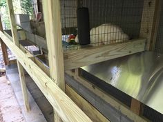 the inside of a chicken coop with metal and wood