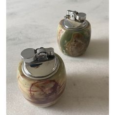 two canisters sitting on top of a white counter