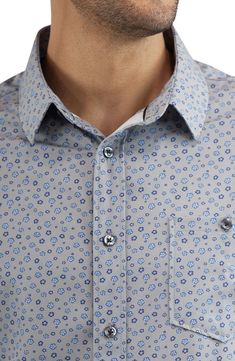 A ditsy floral print brings contemporary appeal to a short-sleeve button-up shirt constructed with comfortable stretch. Front button closure Spread collar Short sleeves Chest button-patch pocket 94% polyester, 6% spandex Machine wash, dry flat Imported Collared Short Sleeve Floral Print Shirt For Spring, Fitted Short Sleeve Printed Button-up Shirt, Short Sleeve Floral Print Shirt For Work, Floral Print Short Sleeve Work Shirt, Workwear Floral Print Short Sleeve Shirt, Patterned Short Sleeve Shirt With Buttons, Casual Floral Print Button-up Short Sleeve Shirt, Casual Short Sleeve Shirt For Business Casual In Spring, Spring Short Sleeve Shirt With Spread Collar And Buttons