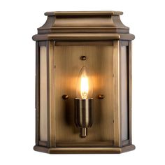 an outdoor wall light with a candle on it