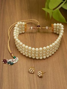 Enhance your traditional look with the Gold Tone Ethnic Multistrand Pearls Choker Necklace & Earring Set for Women. This elegant set is perfect for weddings, parties, and special occasions, offering a blend of tradition and modern style. It also makes an ideal gift for any cultural celebration. Adjustable Bollywood Bridal Necklace For Festive Season, Adjustable Round Beads Jewelry For Diwali, Traditional Pearl Choker For Festivals, Traditional Pearl Choker For Festive Occasions, Adjustable Beaded Jewelry For Diwali, Pearl Jewelry Sets For Diwali Party, Pearl Jewelry For Diwali Party, Pearl Jewelry Sets For Festivals And Celebrations, Pearl Jewelry Sets For Party And Festivals