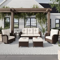 an outdoor living area with furniture and a pergolan style gazebo in the background