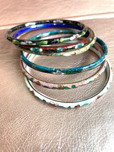 A beautiful selection of cloisonné bangles!  All bangles are sold separately!  these are all Vintage and some are even antique so they have natural science of wear.  please see attached pictures for sizing on each bangle.  these Bengals are well-made, but banging them against something very hard could cause them to break.  as with most vintage items, they should not be worn while doing very active activities like running jogging, working out swimming or any athletics as well as cooking, like sli Vintage Multicolor Enamel Bangle, Traditional Multicolor Enamel Bracelets, Traditional Handmade Enamel Bangle, Bangles Aesthetic, Active Activities, Bangle Stack, Stacking Bangles, Boho Bangle, Natural Science