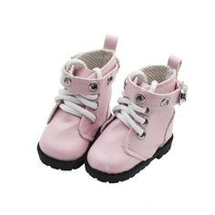 a pair of pink boots with white laces on the bottom and black soles