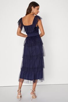 Make an entrance that everyone will love in the Lulus Tier I Come Navy Blue Tulle Square Neck Tiered Midi Dress! Airy tulle shapes this oh-so-sweet dress that features a square neckline, accented by a tying keyhole cutout and a flouncy overlay that flows into fluttery, elasticized straps. Slightly gathered bodice sits atop an elasticized, smocked waist that falls to a tiered skirt that ends at a midi hem. Hidden side zipper/clasp. Fit: This garment fits true to size. Length: Mid-calf length. Siz Chic Blue Mesh Dress For Evening, Chic Blue Mesh Dress For Spring, Blue Sheer Midi Dress For Party, Blue Tiered Tulle Dress, Sheer Tulle Midi Mesh Dress, Spring Tulle Midi Dress With Ruffles, Sheer Tulle Dresses For Garden Parties, Sheer Tulle Dress For Garden Party, Blue Tiered Party Dress