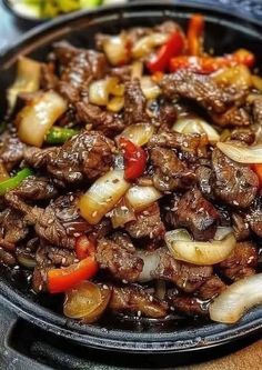 beef and onion stir fry in a skillet