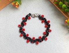 Autumn bracelet, glass bead bracelet, unique bracelet, seed bead bracelet, black red bead bracelet everyday bracelet Materials: Czech beads. Size: length - 17 cm (6 1/2 inches ), width 1.3 cm (1/2 inches ) The color of the live product may differ from the photo depending on the brightness settings of your monitor. 100% handmade, so each subsequent copy may be partially different from the photo. Bracelet can be made in another color, write to me if you need to change something. You can see these and other works on my Instagram page: mila_kim_handmade Black Flower Bracelet, Black Flower Beaded Bracelets For Gift, Black Flower Shaped Beaded Bracelets For Gift, Black Flower Shaped Beaded Bracelets, Handmade Black Flower Bracelets, Black Flower Beaded Bracelets, Black Flower-shaped Jewelry With Colorful Beads, Red Flower-shaped Beaded Bracelets For Jewelry Making, Red Bead Bracelet