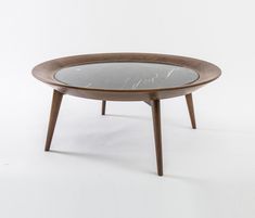 a wooden table with a glass top and legs on the bottom, against a white background