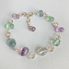 Rosary bracelet with natural Fluorite, smooth and transparent stone cut, natural smooth teardrop Amethysts and 925 silver. Clasp and components in 925 silver. Artisanal creation, entirely done by hand. For any changes contact me without hesitation. Thank you. Length 17.5 + 2 cm = 19.5 cm (inch 6.88 + 0.78) Size of the stones: approximately 7 x 8 mm. After inspection it will be packaged in a nice gift box. Unique piece ready for delivery. Fluorite Bracelet, Rosary Bracelet, Amethyst Bracelet, Stone Cuts, Diy Jewellery, Unique Pieces, 925 Silver, Beading, Jewelry Bracelets