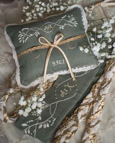 two decorative pillows with ribbons tied around them