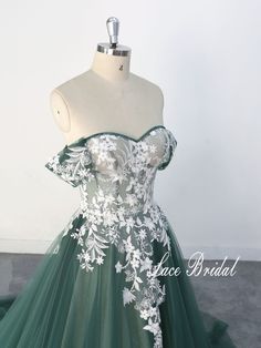 a green and white ball gown with flowers on it