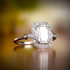 an old - fashioned diamond ring sits on a table