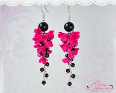 "Black pink earrings Hot pink statement earrings Hot pink bridesmaid earrings Flowers long earrings Blooming earring gift Floral pink jewelry Flowers Long earrings with Fuchsia pink flowers, and supplemented with Black glass beads. Hot Pink Flowers Lilacs, made of polymer clay. For these flowers I used high quality polymer clay. Each flower is made by hand in a special technique. Fuchsia Black earrings can be a perfect complement to your dress. Bright floral earrings will be a perfect gift for her Accentuate your individuality with the help of these floral earrings! Length with hooks is about 8.4cm/3.30\" ✿These earrings can be made to order. Please allow 3-7 days for production time. ✿ Real colors may slightly differ from one monitor to another, as it depends on specific monitor settings.