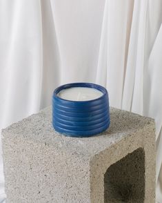 a cement block with a blue candle in it