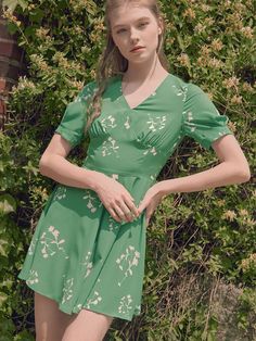 Editor's NotesThe Garden Party Mini Dress is a mini dress made from a light and subtle glossy, silky fabric featuring print details inspired by summer flowers in the Finnish garden.- V-neck- Sleeves with tuck details- Short length- Flare line Measurements(in.)Size: Size [34(XS)/36(S)]- Shoulder: 13.78 in / 14.17 in - Bust: 33.86 in / 35.43 in - Waist: 27.56 in / 29.13 in - Hem: 82.68 in / 83.86 in - Sleeve: 9.84 in / 9.84 in - Length: 31.69 in / 31.89 in Model Info: (Ellish) Height 5' 7, Top S size/ Bottom 27 size / Wearing a size 34 Composition & Care- Fabric: 100% Polyester- Dry Cleaning Designer- by IvanaHelsinki Spring Floral Print V-neck Dress For Party, Elegant Green V-neck Floral Dress, Ditsy Floral Print V-neck Dress For Garden Party, Green V-neck Knee-length Dress For Spring, Summer Ruched Mini Dress With V-neck, Lined Mini Dress For Garden Party, Chic Green V-neck Floral Dress, Green Mini-length V-neck Dress, Spring V-neck Ruched Dress